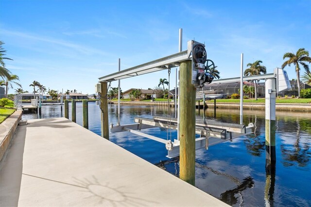 dock area with a water view and boat lift