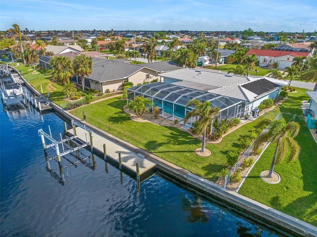 birds eye view of property with a water view and a residential view