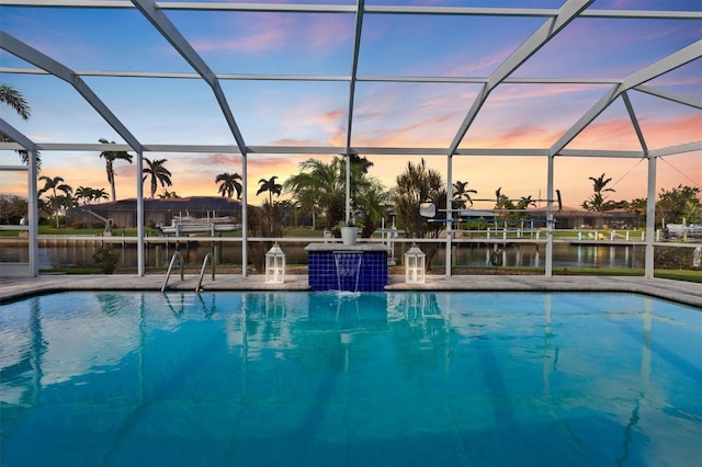 outdoor pool with a water view and a lanai