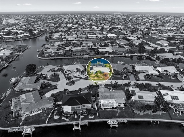 birds eye view of property featuring a water view and a residential view