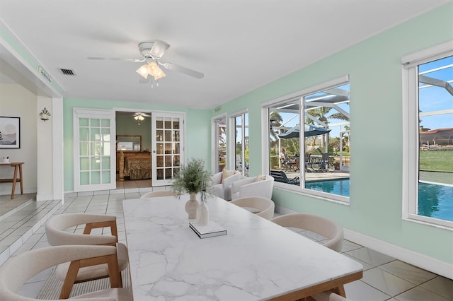 sunroom with ceiling fan and visible vents