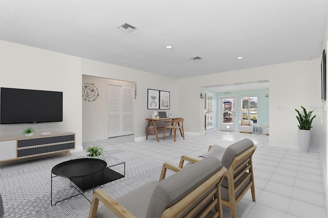 living room featuring recessed lighting, visible vents, and light tile patterned floors