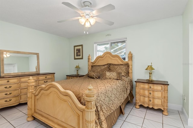 bedroom with light tile patterned floors, a ceiling fan, and baseboards