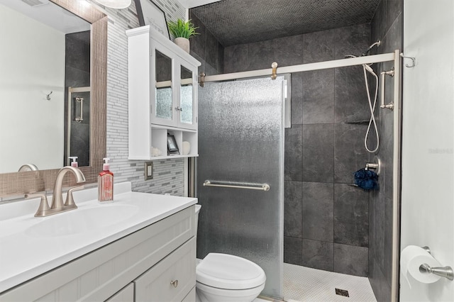 bathroom featuring a stall shower, visible vents, decorative backsplash, toilet, and vanity