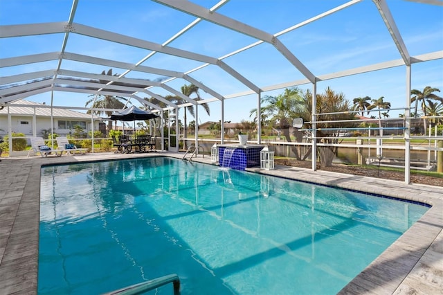 outdoor pool with a lanai and a patio