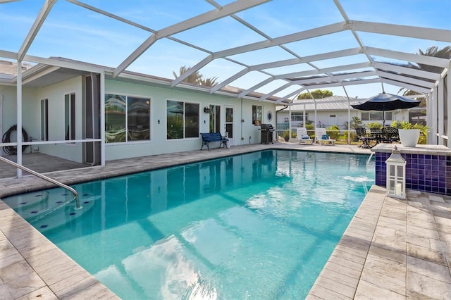 pool with a lanai, a patio, and grilling area