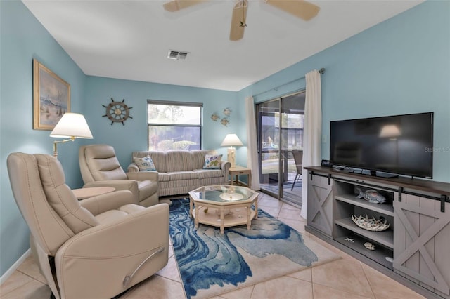 living room featuring light tile patterned flooring and ceiling fan