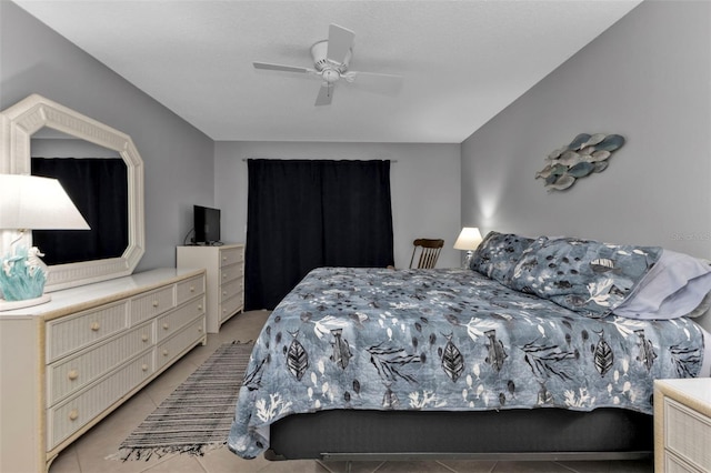 tiled bedroom featuring ceiling fan