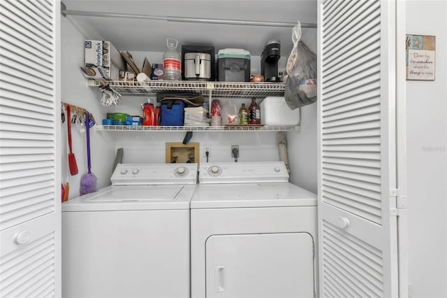 clothes washing area with washing machine and dryer