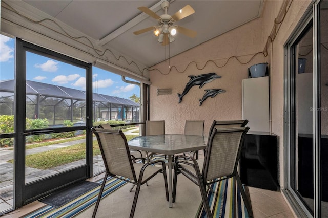 sunroom / solarium featuring ceiling fan and lofted ceiling with beams