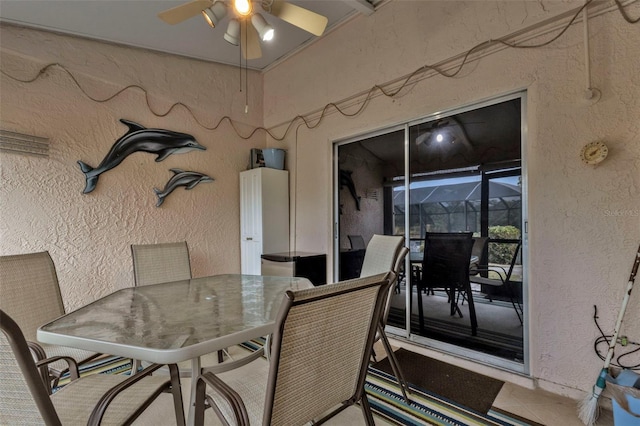 view of patio / terrace with ceiling fan and glass enclosure