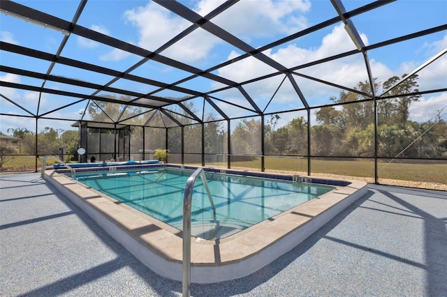 view of swimming pool featuring a lanai and a patio area