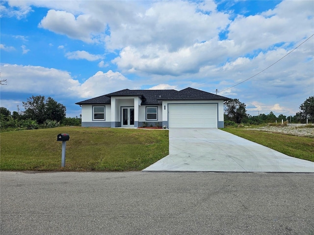 view of front of property with a front yard and a garage