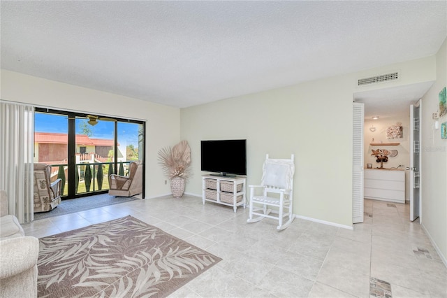 tiled living room with a textured ceiling