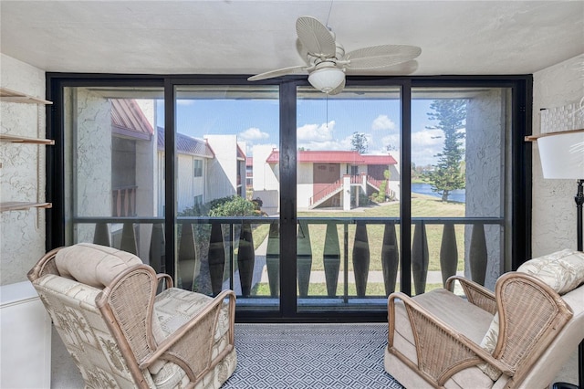 sunroom / solarium featuring ceiling fan