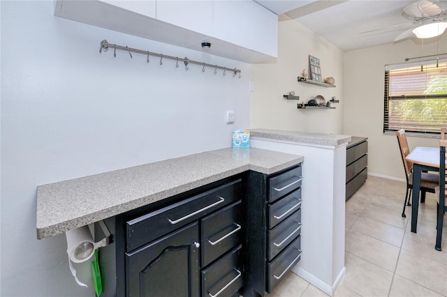 kitchen with light tile patterned flooring and ceiling fan