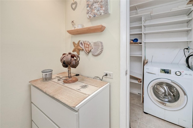 laundry area featuring light tile patterned floors and washer / clothes dryer