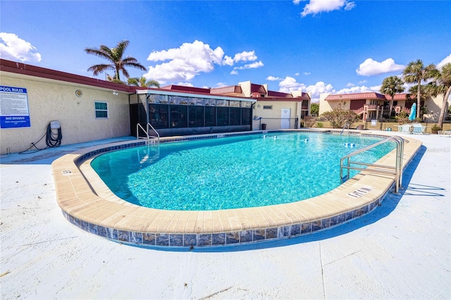 view of swimming pool with a patio area