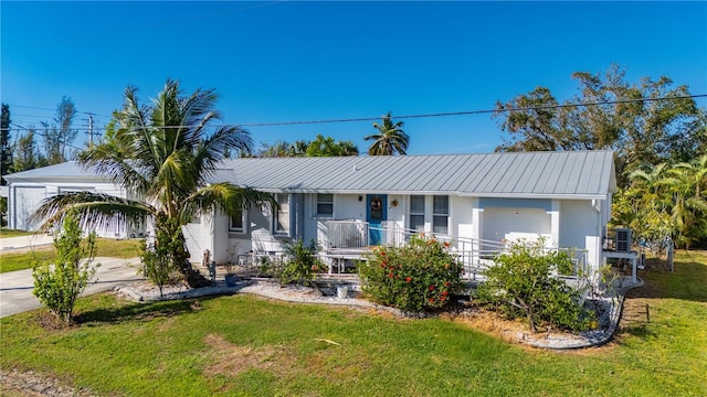 single story home featuring covered porch, a carport, and a front lawn