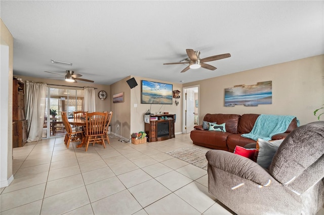 living room featuring light tile patterned floors and ceiling fan