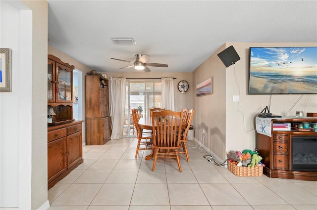 dining area featuring light tile patterned floors and ceiling fan