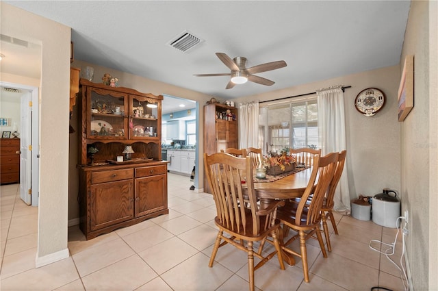 dining area with light tile patterned flooring and ceiling fan