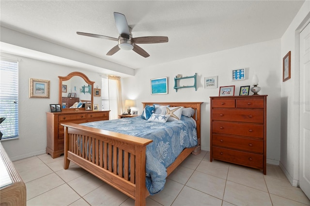 tiled bedroom with a textured ceiling and ceiling fan