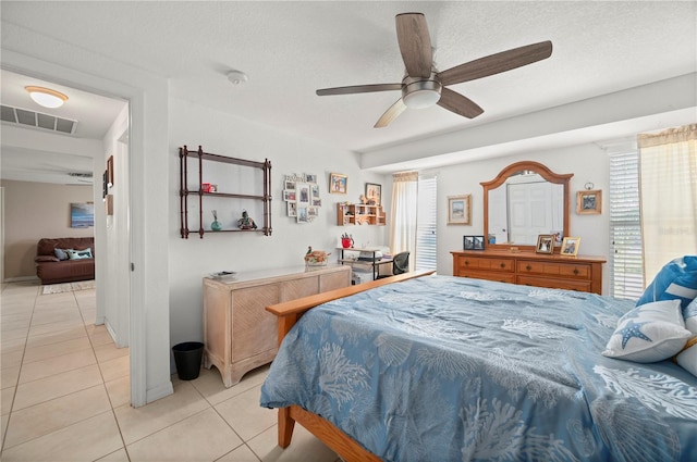 tiled bedroom featuring multiple windows, a textured ceiling, and ceiling fan