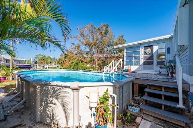 view of swimming pool featuring a wooden deck