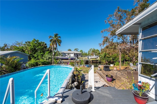 view of swimming pool with a deck with water view