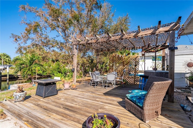 wooden terrace featuring a fire pit and a pergola