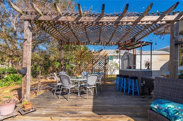 deck with a pergola and exterior bar