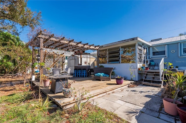 view of patio featuring a pergola and a deck