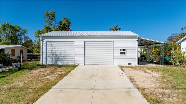 garage with a yard and a carport