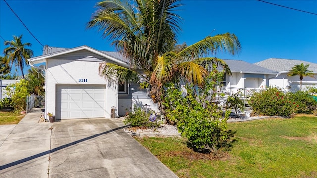 view of front of property with a front lawn and a garage