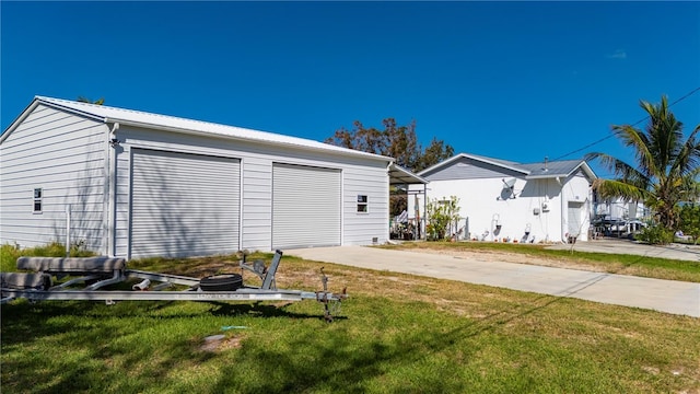 exterior space with a garage and a lawn