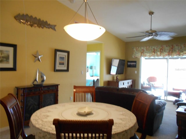 carpeted dining space featuring ceiling fan