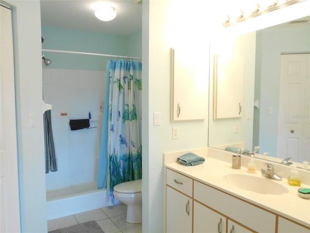 bathroom featuring vanity, toilet, tile patterned floors, and curtained shower