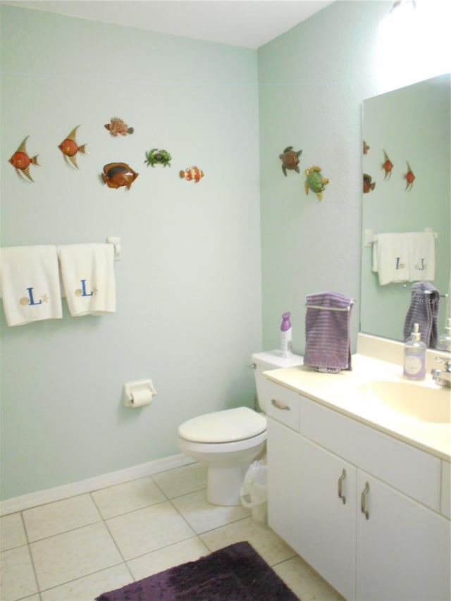 bathroom featuring vanity, toilet, and tile patterned floors