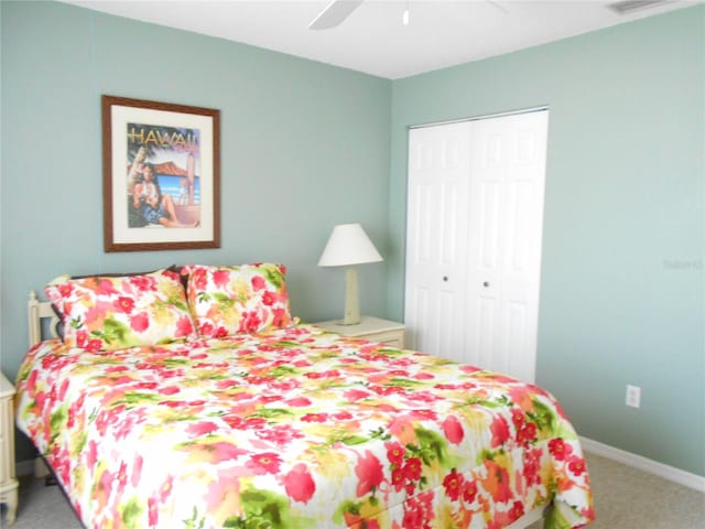 carpeted bedroom featuring a closet and ceiling fan