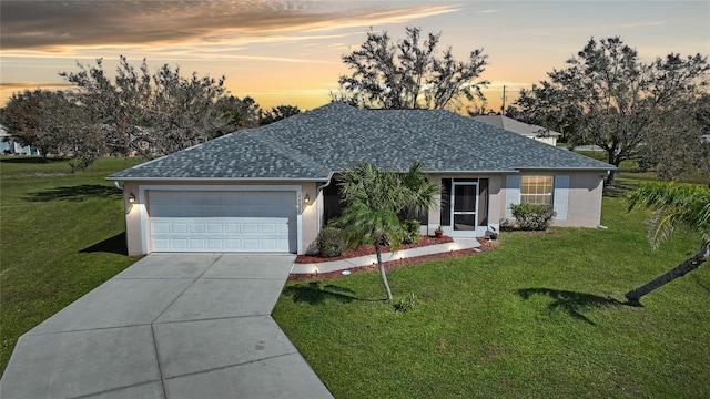 single story home featuring a yard and a garage