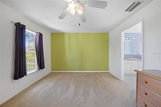 carpeted empty room with sink and ceiling fan