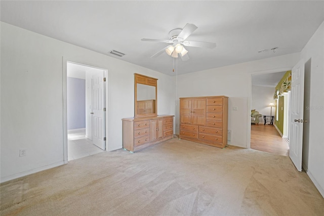 unfurnished bedroom featuring ceiling fan and light carpet