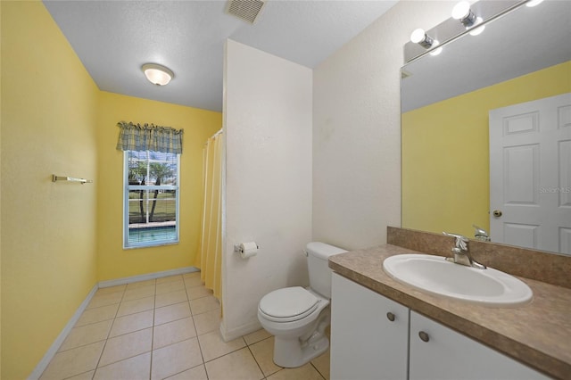 bathroom featuring vanity, a textured ceiling, toilet, and tile patterned flooring