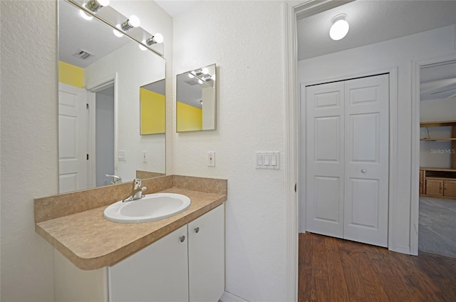 bathroom with vanity and hardwood / wood-style flooring