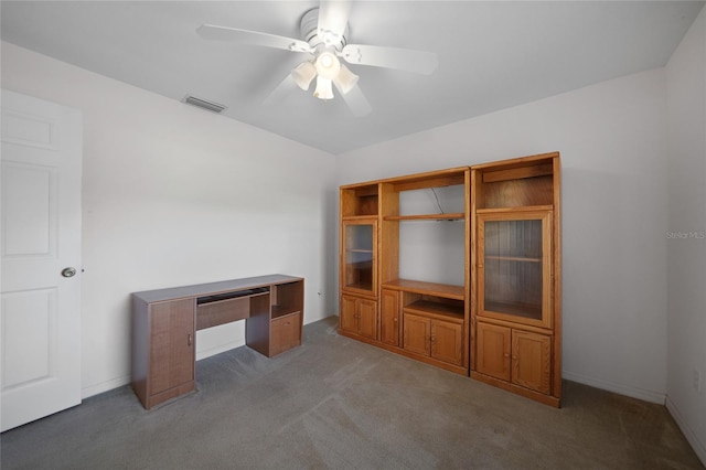 unfurnished office featuring carpet and ceiling fan