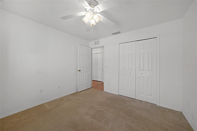 unfurnished bedroom featuring a closet, carpet flooring, and ceiling fan