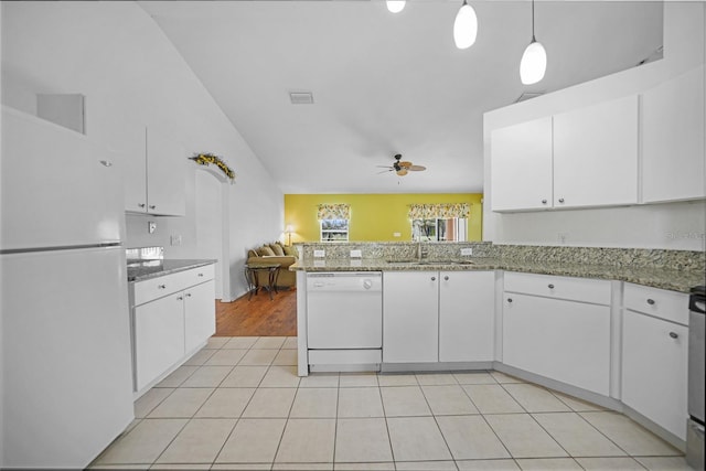 kitchen featuring white appliances, decorative light fixtures, and white cabinets