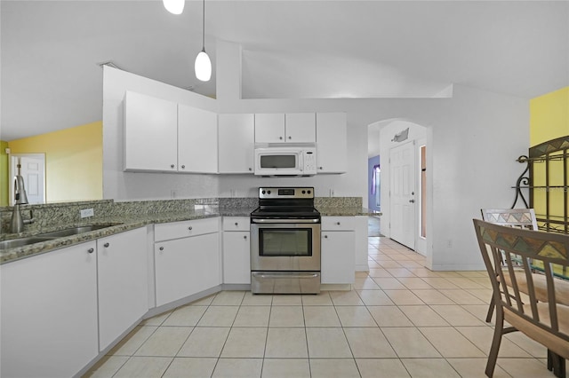 kitchen featuring white cabinets, vaulted ceiling, and stainless steel range with electric cooktop