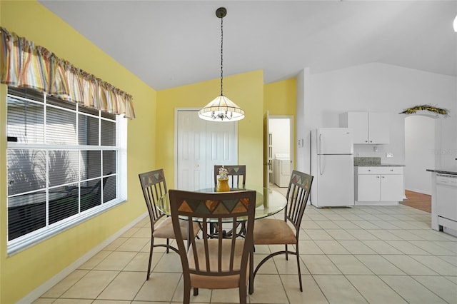 dining space with vaulted ceiling, an inviting chandelier, and light tile patterned floors